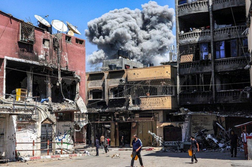 A plume of smoke rises after an Israeli strike on Jabalia, in northern Gaza Strip (14 May 2024)