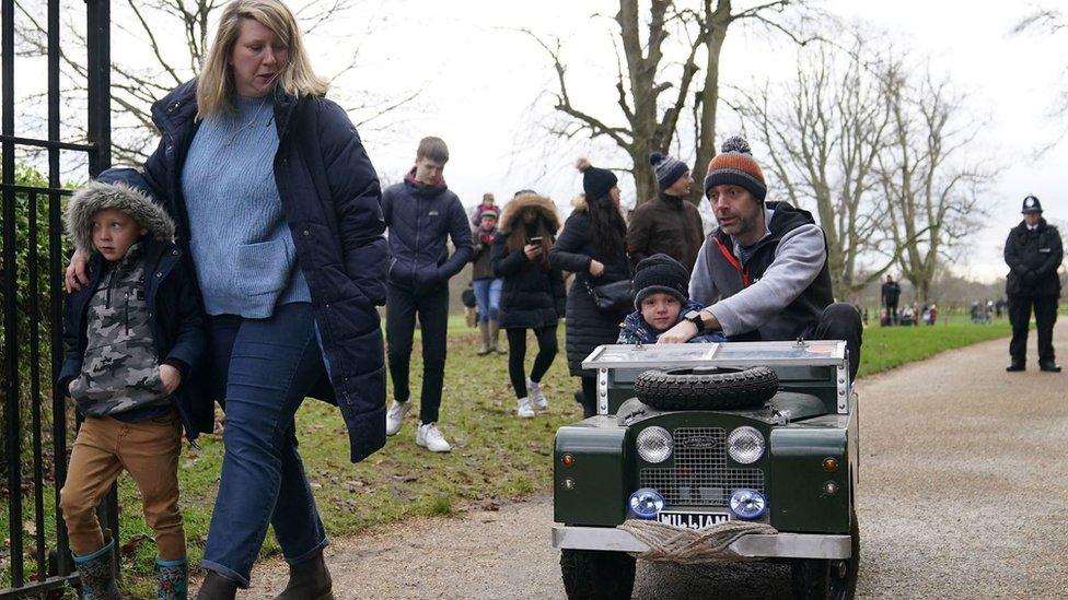 Family at Sandringham with toy Land Rover