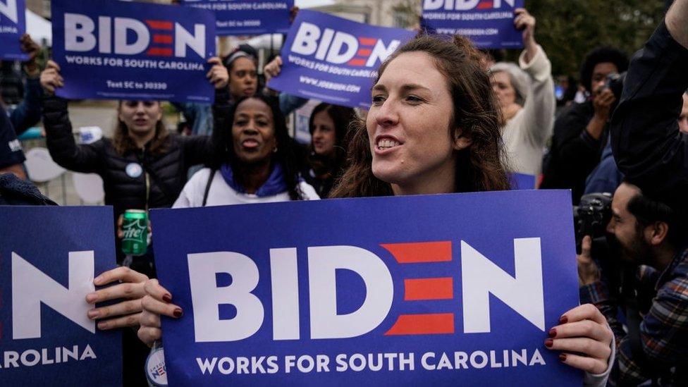 Voters in South Carolina hold signs supporting Joe Biden's presidential campaign