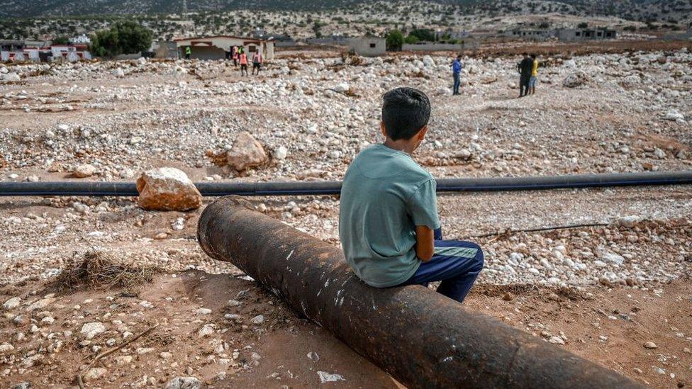 Libyan child looking out on destruction after a flood