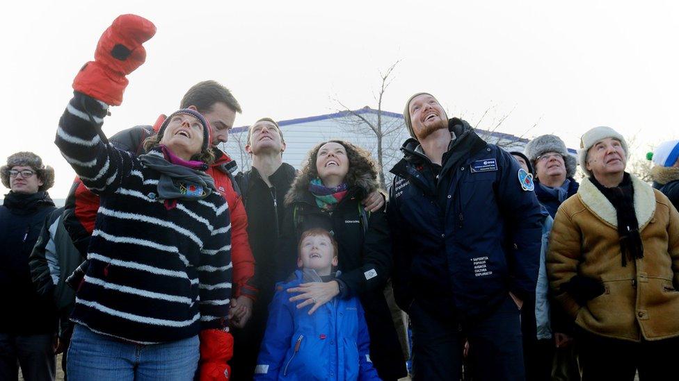 Tim Peake's wife Rebecca (centre, their son Thomas and others look up, watching the launch of a spacecraft in Kazakhstan.