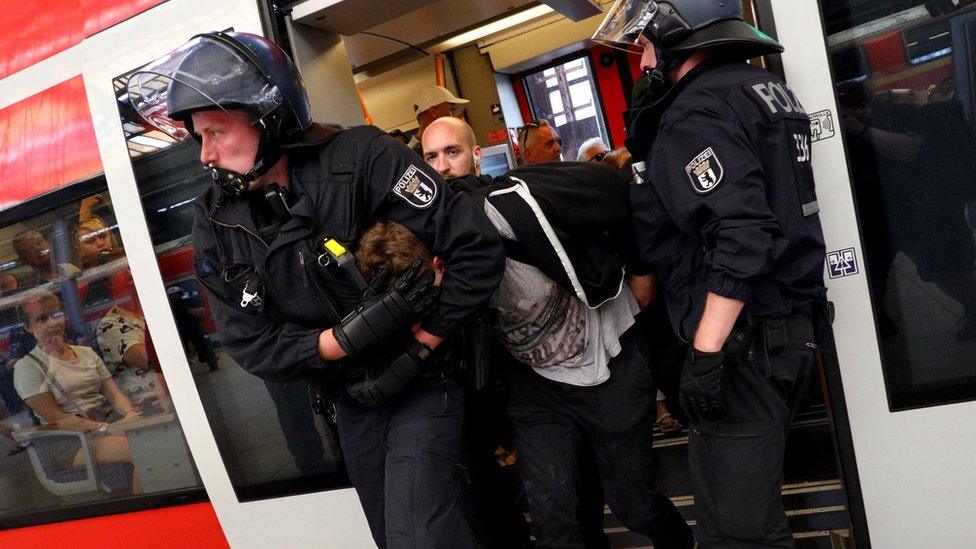 Police arrest a man on a platform of Friedrichstrasse station after a demonstration of the "Alternative for Germany" (AfD) party at the main station in Berlin, Germany, 27 May 2018.