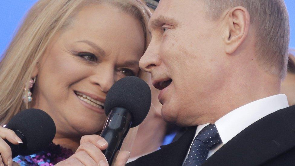 Vladimir Putin and Russian pop singer Larisa Dolina sing the Russian national anthem at a rally in central Moscow in 2015