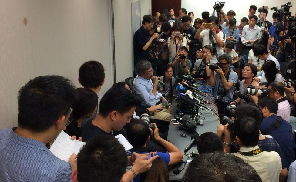 Formerly jailed publisher Lam Wing Kee surrounded by reporters at a press conference in Hong Kong - 16 June 2016