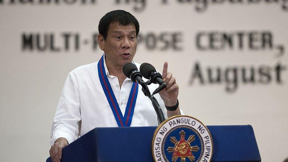 Philippine President Rodrigo Duterte gestures as he talks during the 115th Police Service Anniversary at the Philippine National Police (PNP) headquarters