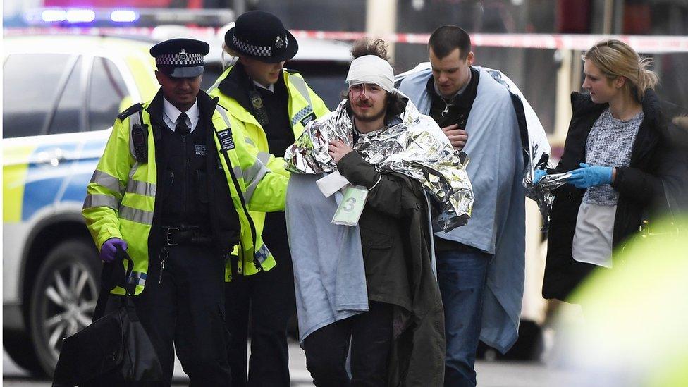 One of the injured is helped by police