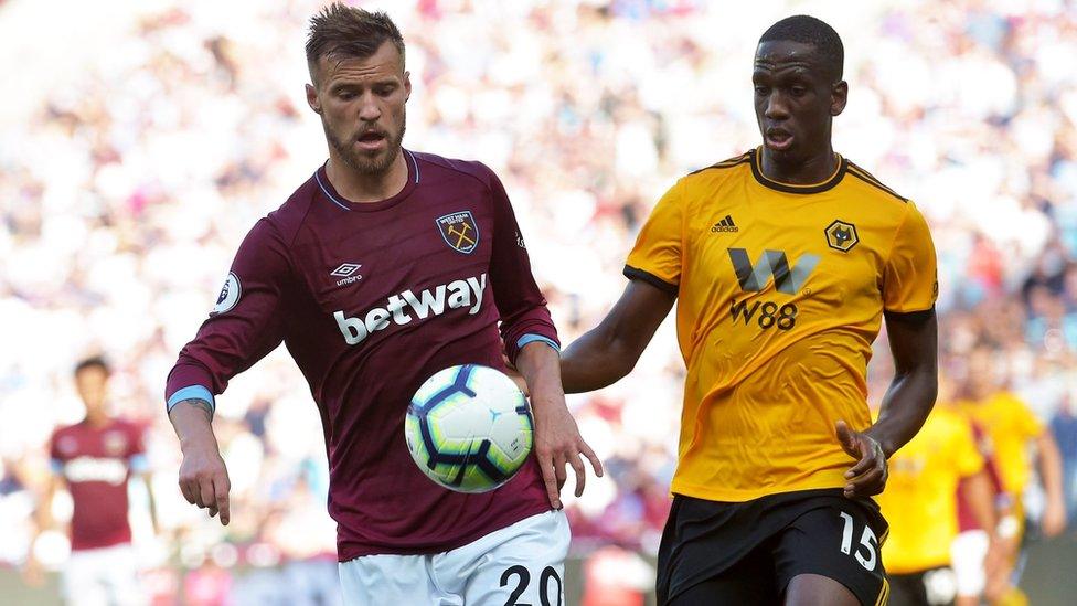 Andriy Yarmolenko of West Ham United and Willy Boly of Wolverhampton Wanderers