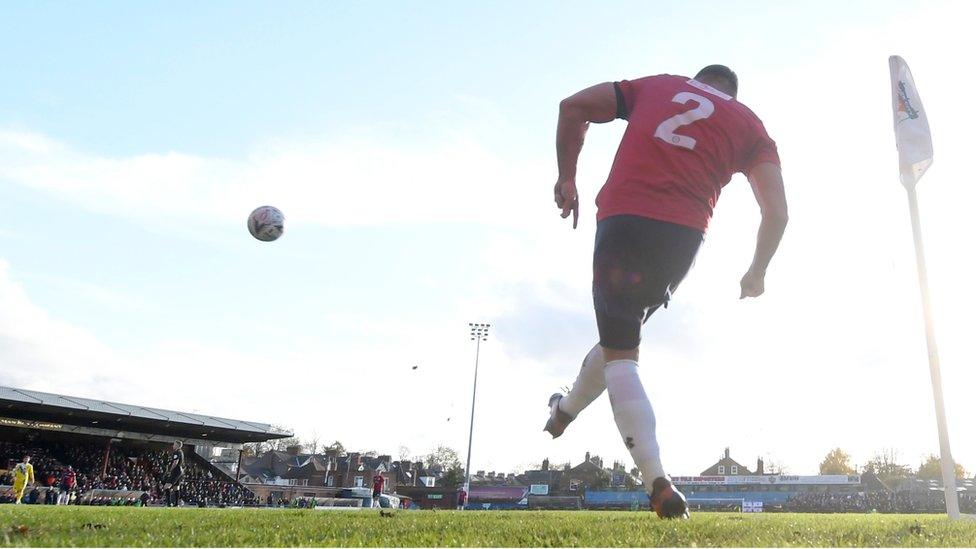 A player takes a corner at Bootham Crescent