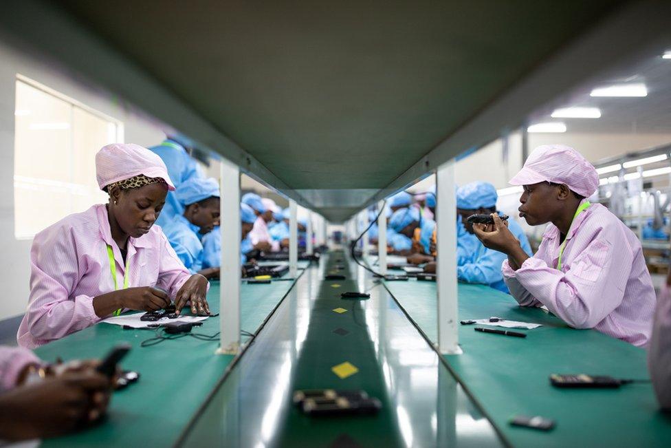 Factory workers assemble mobile phone parts at Uganda's first mobile phone factory which has been operating in Namanve, near Kampala, since August 2019.