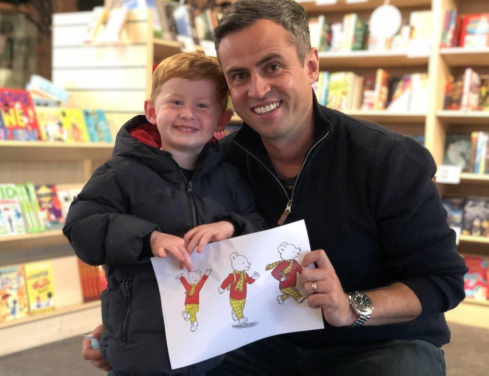 Ian Dodds with his son Charlie holding a Rupert picture