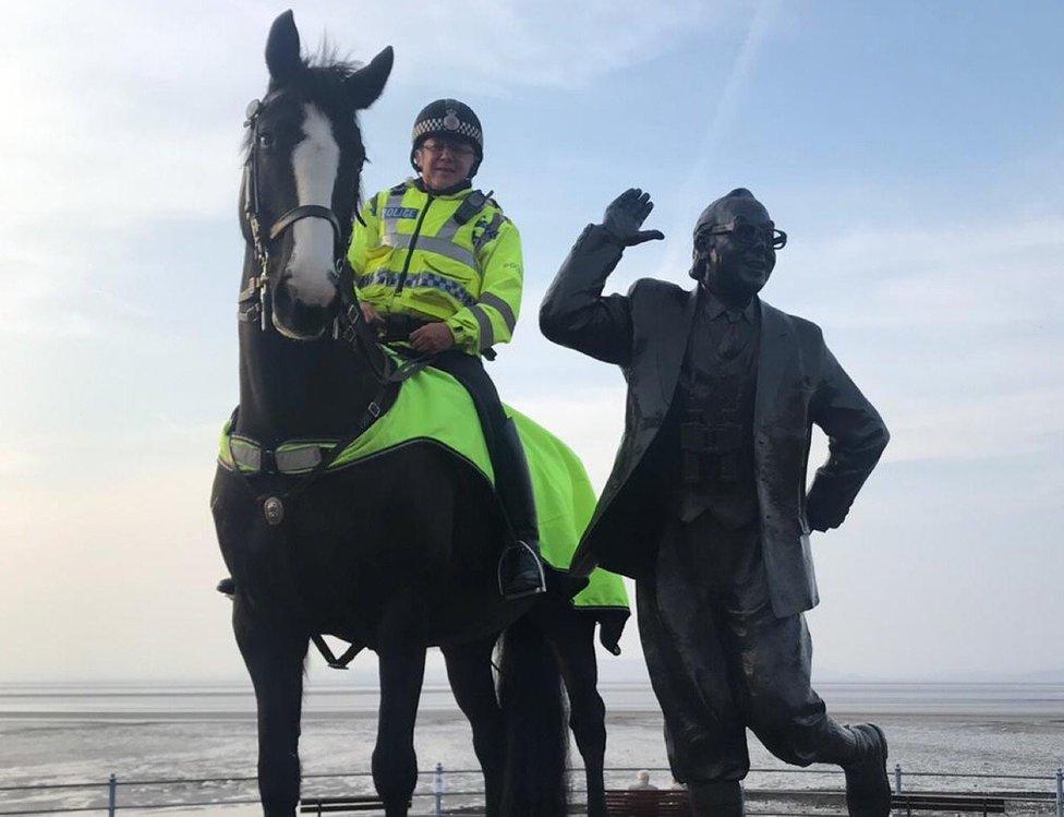 Morecambe police horse with Eric Morecambe statue