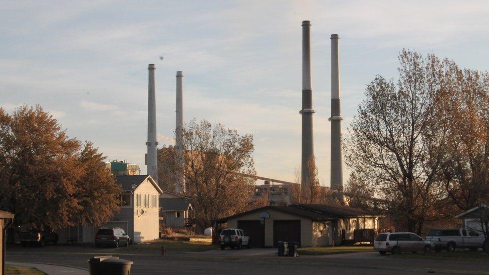 Four smokestacks from the local power plant over Colstrip, Montana