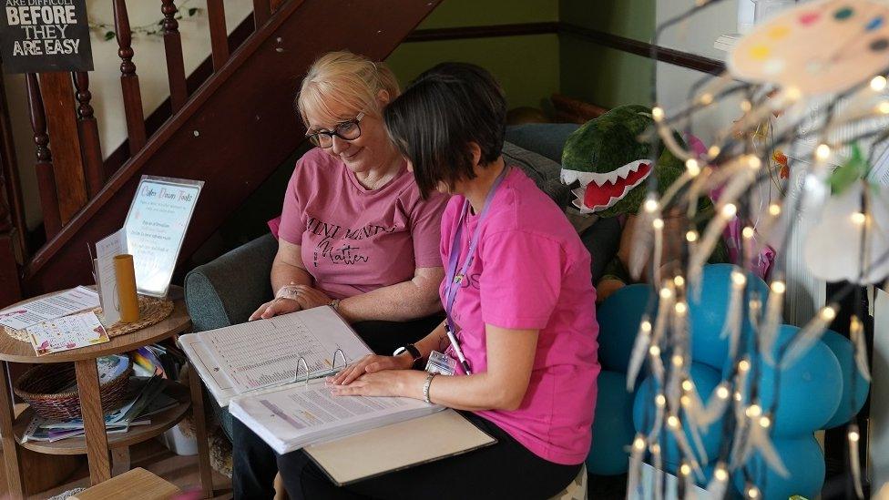 Nursery owner looking at book