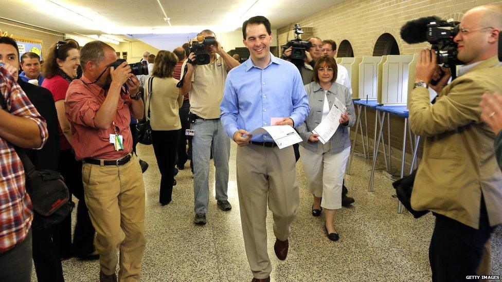 isconsin Gov. Scott Walker walks past media after he filled out his ballot at Jefferson School to vote in the gubernatorial recall election June 5, 2012 in Wauwatosa, Wisconsin.