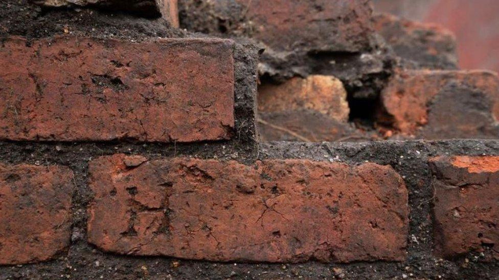 The initial H carved into the brickwork, as found by archaeologists