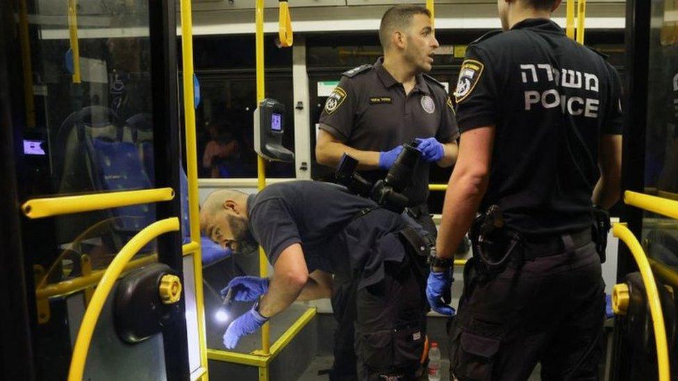 Israeli security inspect a bus after an attack outside Jerusalem's Old City, August 14, 2022.