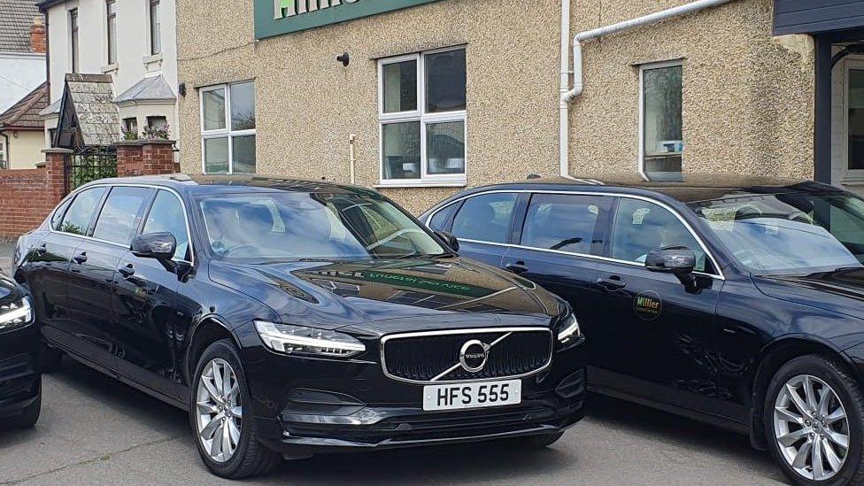 Three black limousines in front of Hillier Funeral Services