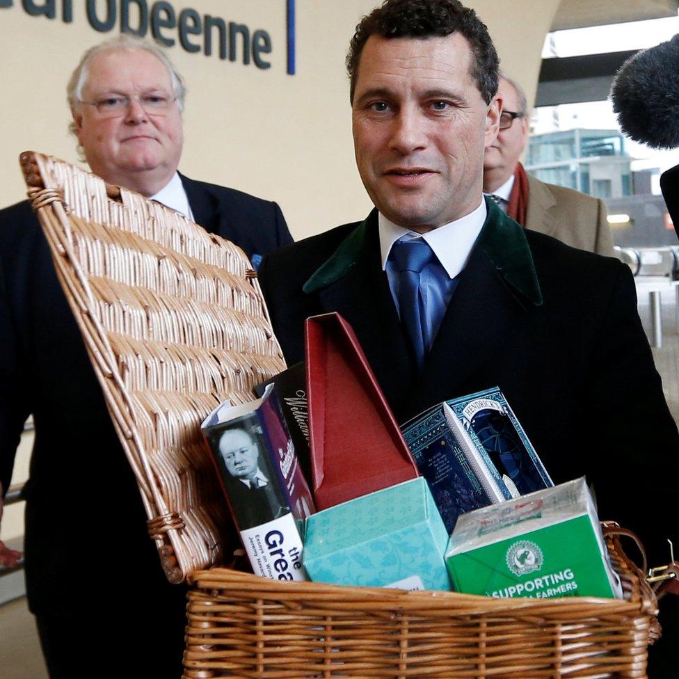 Steven Woolfe carries the Brexit hamper with Digby Jones following