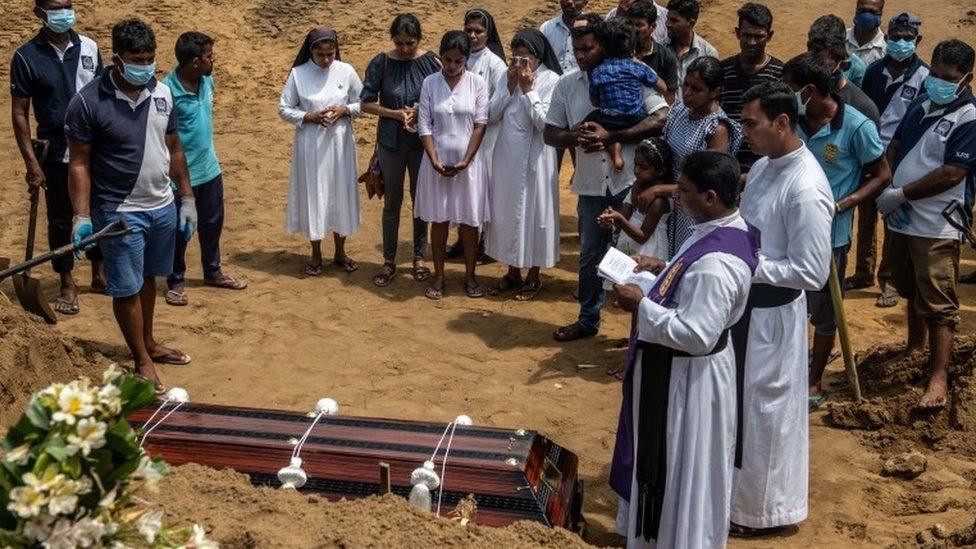 Mourners attend the funeral of a person killed in the Easter Sunday attack in Negombo