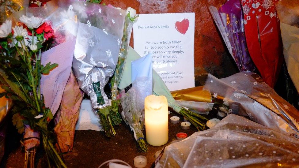 Candles, flowers and written tributes have been left outside the property