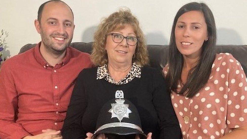 Andy Hassan, his mum Ceri and sister Aimee with Derrick’s helmet