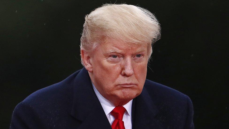 US President Donald Trump looks on as he visits the American Cemetery of Suresnes, outside Paris, on November 11, 2018 as part of Veterans Day and the commemorations marking the 100th anniversary of the 11 November 1918 armistice, ending World War I.