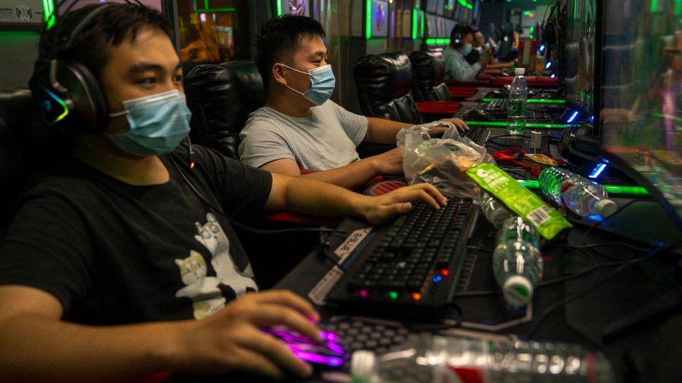 People play online video games in a game arcade on September 11, 2021 in Beijing, China.