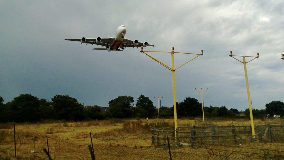 A plane flying over Heathrow Airport