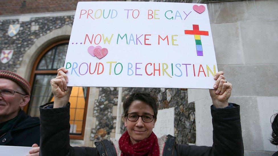 Women holding placard