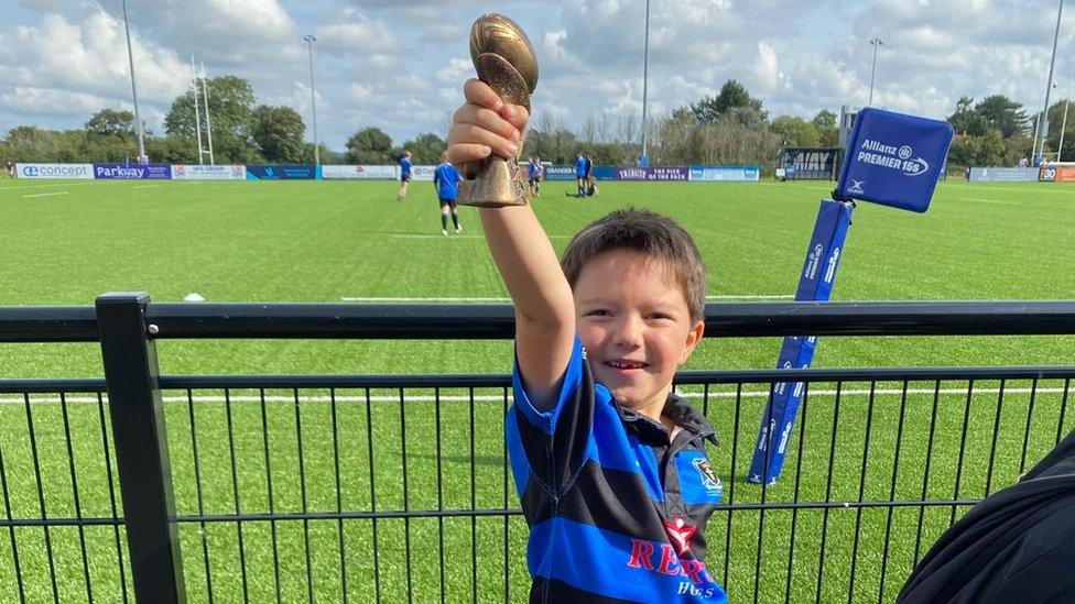 Barney holding a trophy