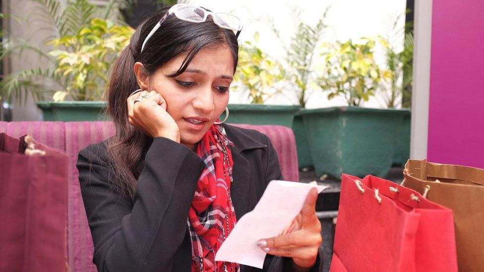 Woman looking at receipt