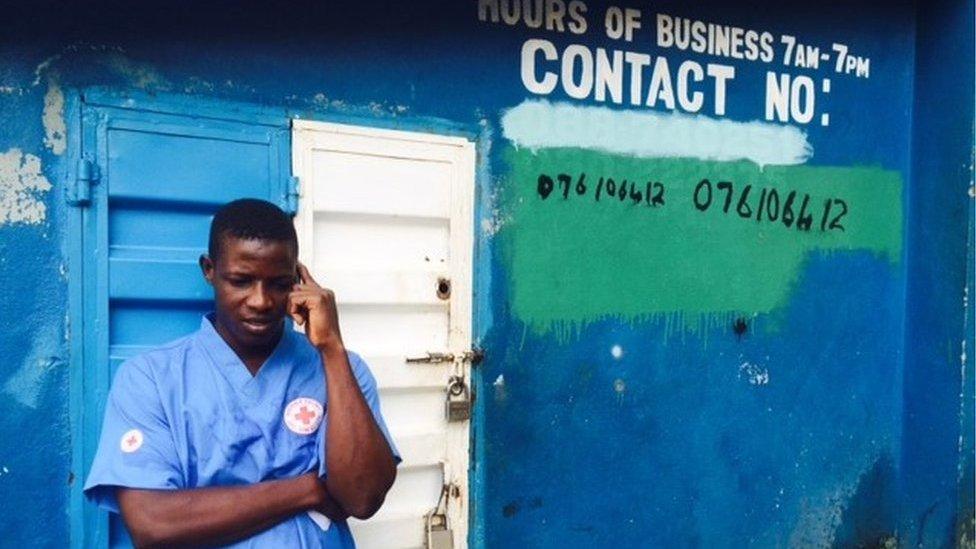 Red Cross worker Mohamad Kamara receives a call to retrieve a body