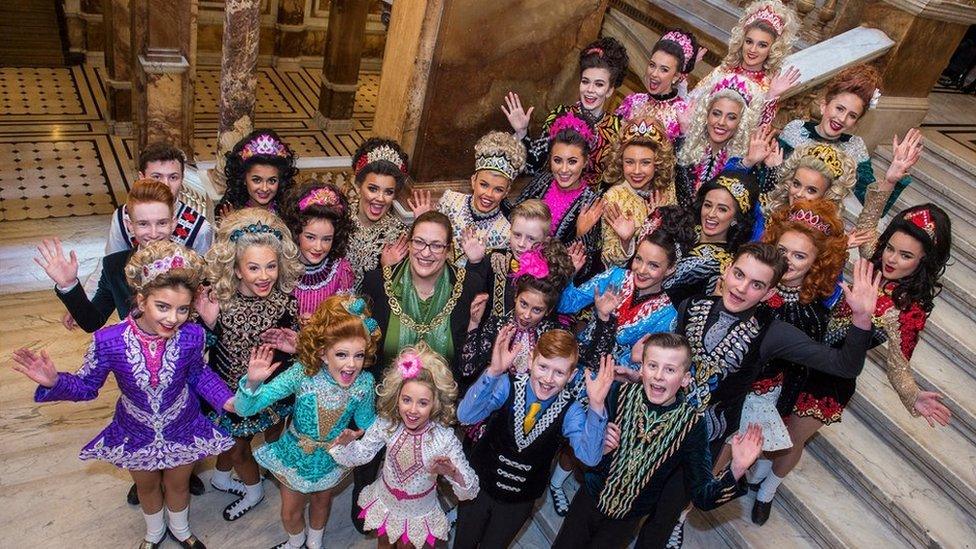 Irish dancers posing in their colourful costumes during a previous competition