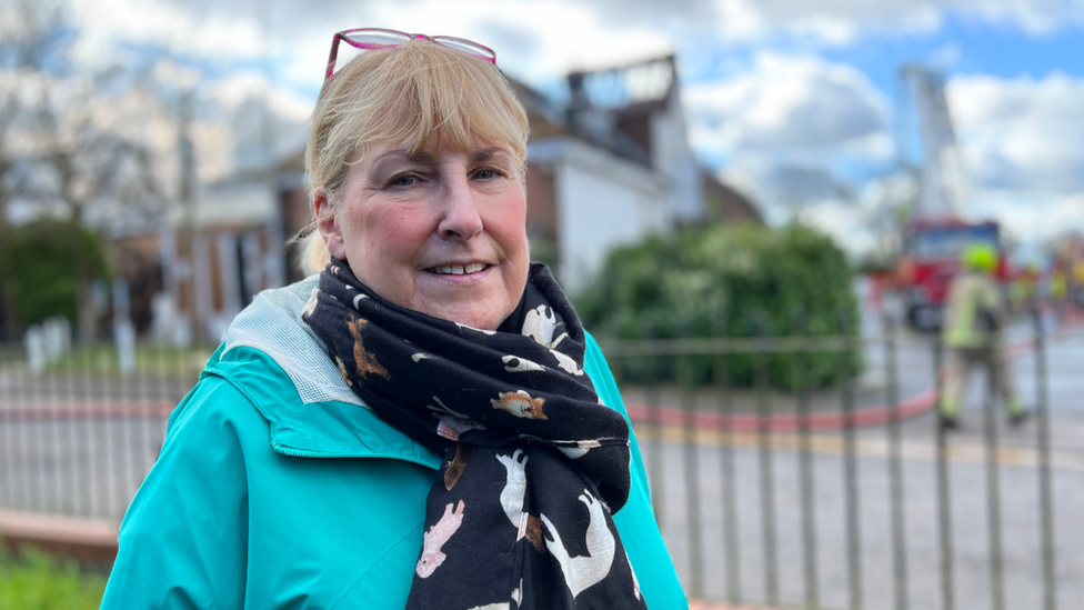 Julie Moat wearing a bright blue coat and scarf