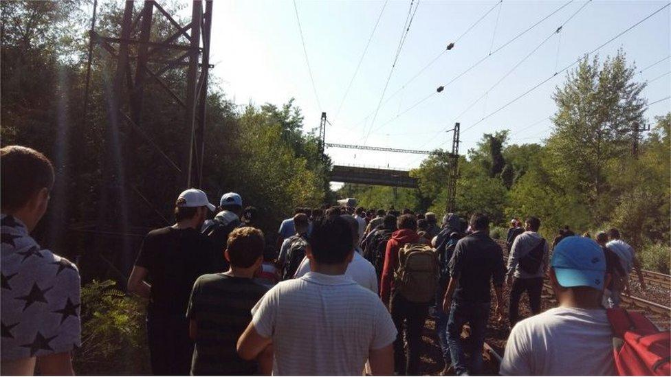 Migrants hoping to reach the Austrian border disembark from a train in the Hungarian town of Bicske, 40km (25 miles) from Budapest (4 September)