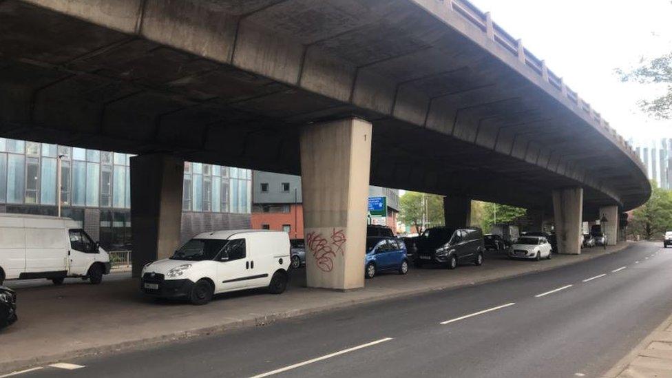 Cars parked under bridge