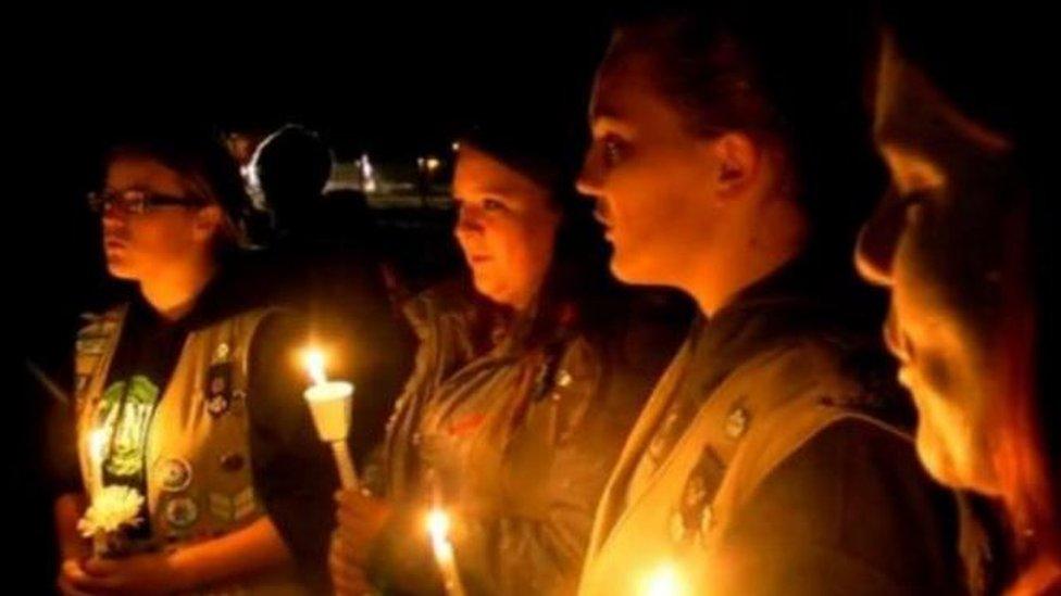 Fellow Girl Scouts sang at a vigil held for the victims on Sunday