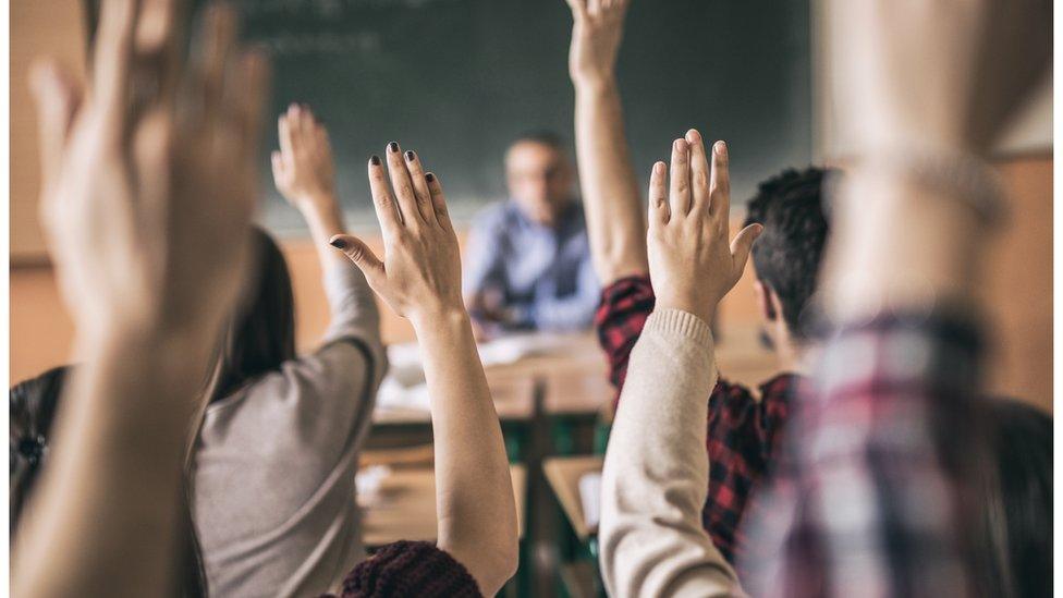 Pupils with their hands up