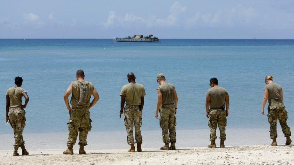 US soldiers wait on a beach for a navy landing craft as their unit evacuates in advance of Hurricane Maria, in Charlotte Amalie, St Thomas, US Virgin Islands. Photo: 17 September 2017