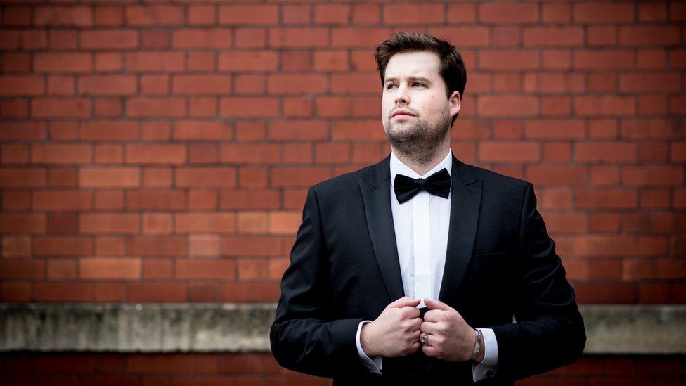 Adam in a suit for a promotional shot