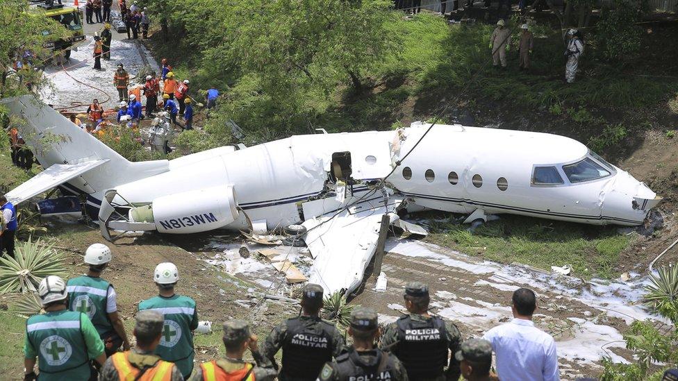 Authorities work in the area where an executive jet plane with US registration crashed in Tegucigalpa, Honduras