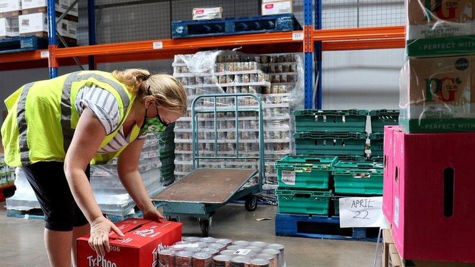 volunteer holding food crate