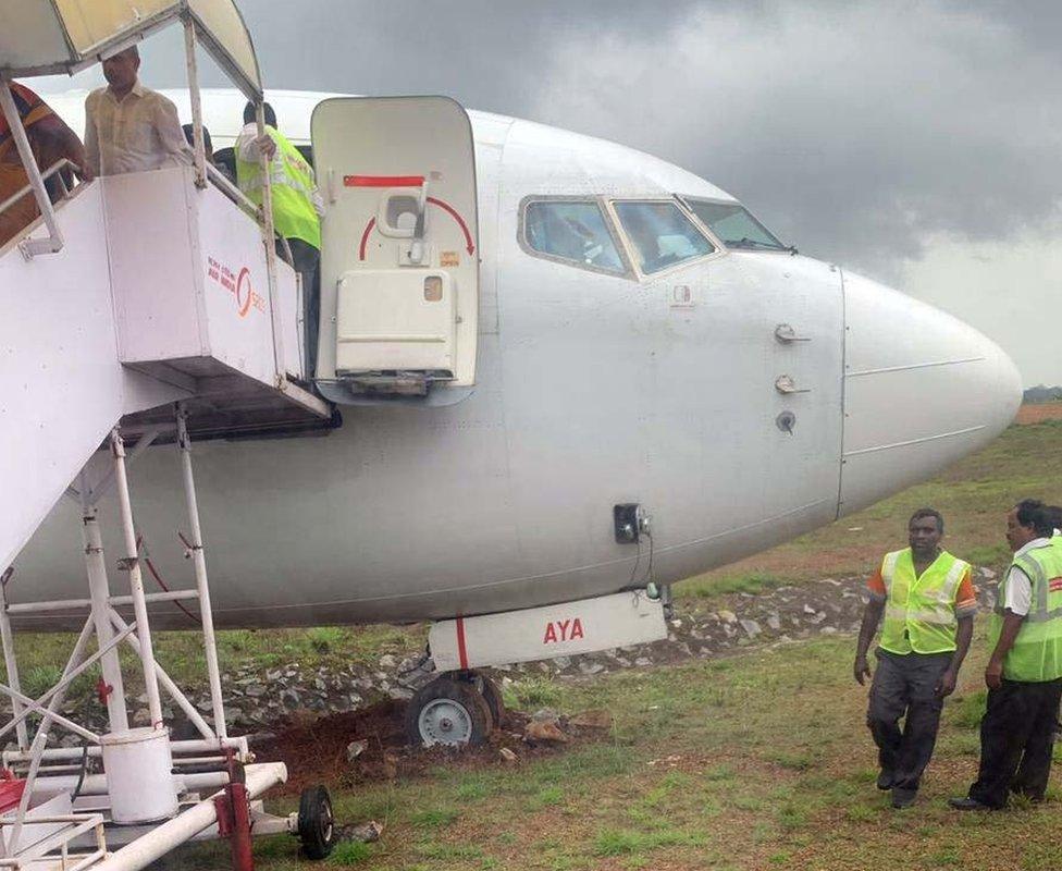 Airport Security officials check the tyres of the IX384 Air India Express Dubai to Mangalore