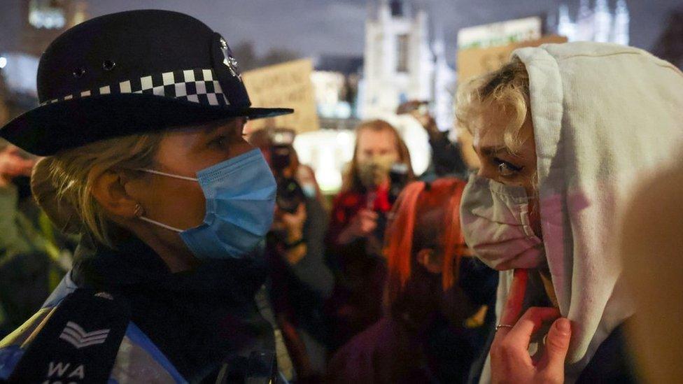 A police woman with a protester