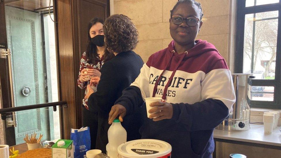 Modupe and colleagues serving tea and cake at the event