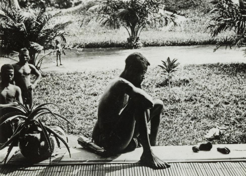 Alice Seeley Harris's 1904 photograph of Nsala, looking at his five-year-old daughter's severed hand and foot