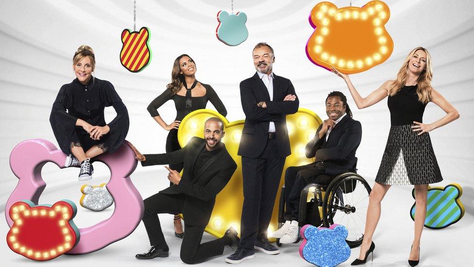 Mel Giedroyc, Rochelle and Marvin Humes, Graham Norton, Ade Adepitan and Tess Daly pose with different Pudsey Bear objects.