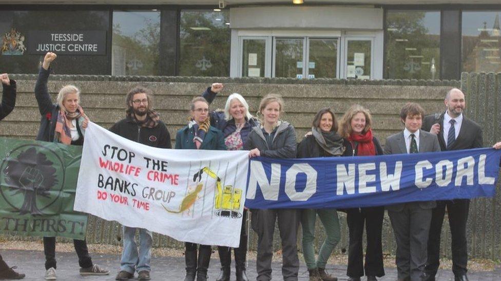 Defendants and supporters outside court