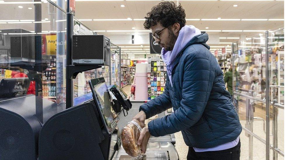 Stock image of a man using a self-scan