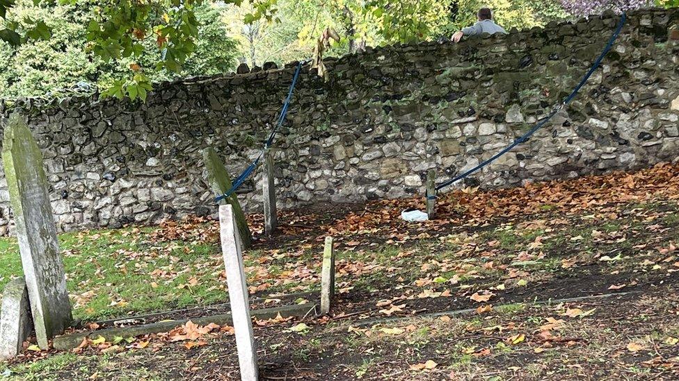 Ropes attached to gravestones